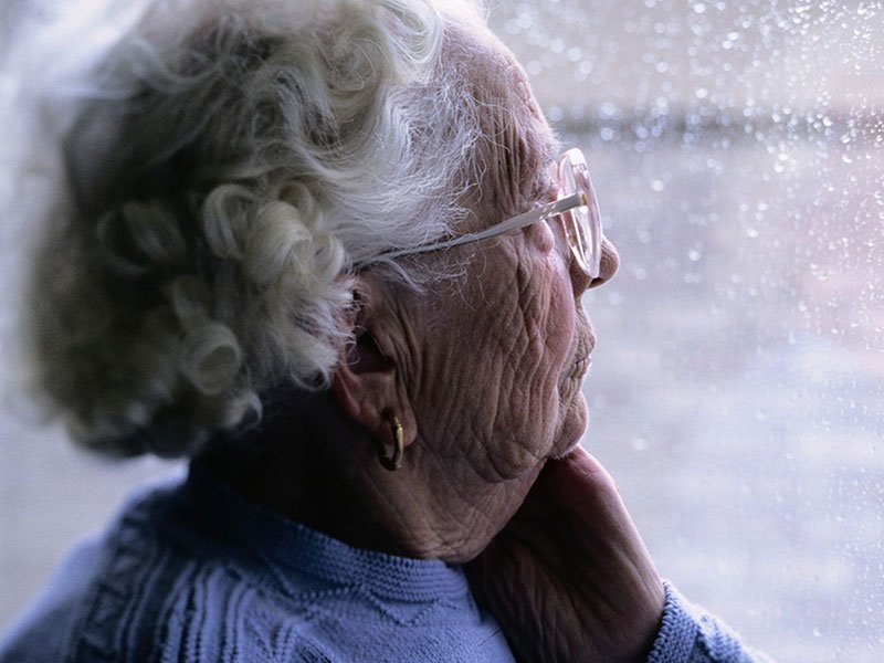 Elder Justice services - Photo of an elderly woman looking out a window