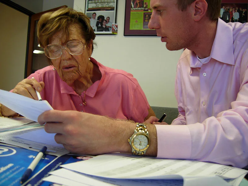 Homeowner Protection & Fraud Prevention - Photo of an elderly woman homeowner meeting with a lawyer