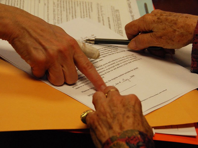 Low-Income Taxpayer Clinic - Photo of two women's hands pointing at a tax document